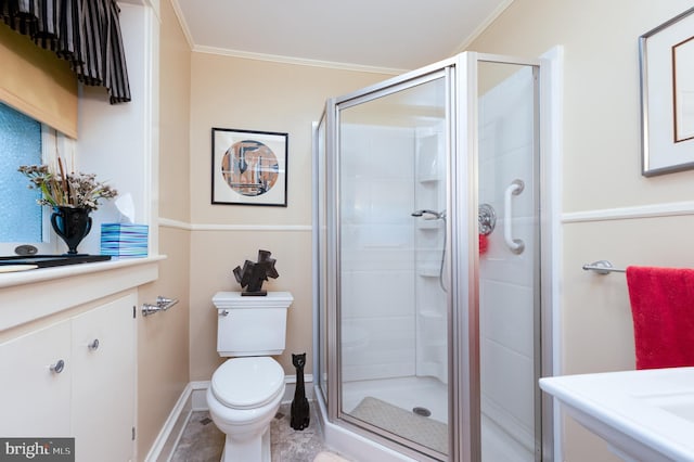 bathroom with ornamental molding, toilet, and walk in shower