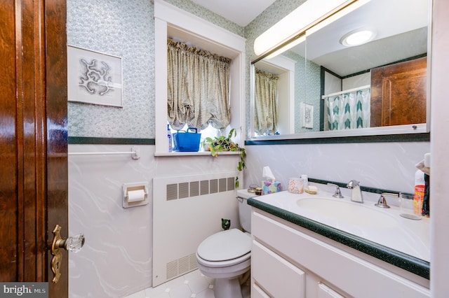 bathroom featuring vanity, radiator heating unit, tile patterned floors, and toilet