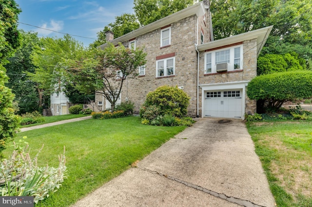 view of front facade featuring a garage and a front lawn