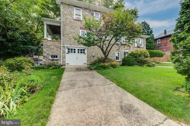 view of front facade with a garage and a front yard