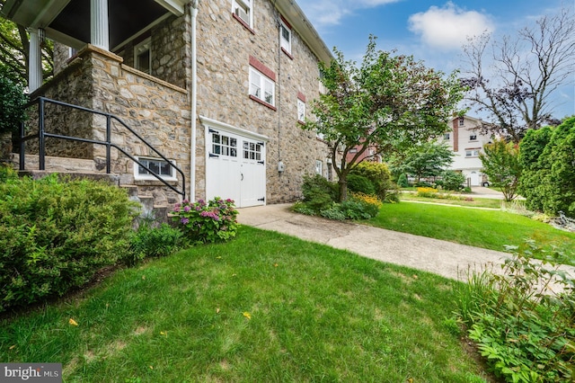 view of property exterior featuring a yard and a garage