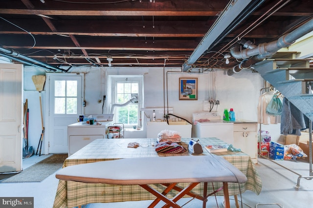 basement featuring separate washer and dryer and sink