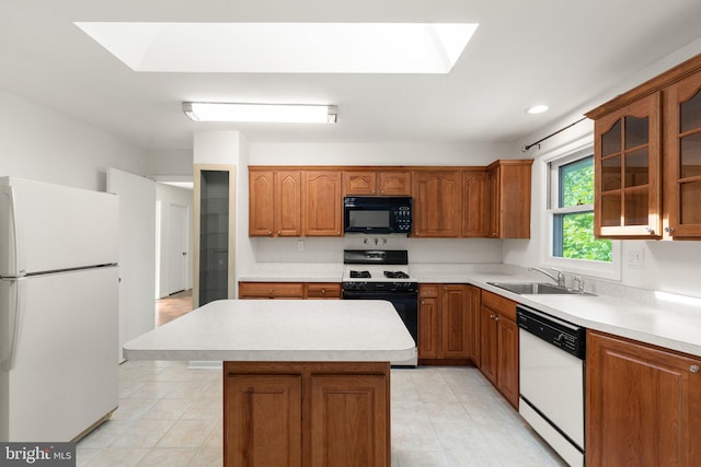 kitchen with light tile patterned flooring, sink, a skylight, a kitchen island, and white appliances