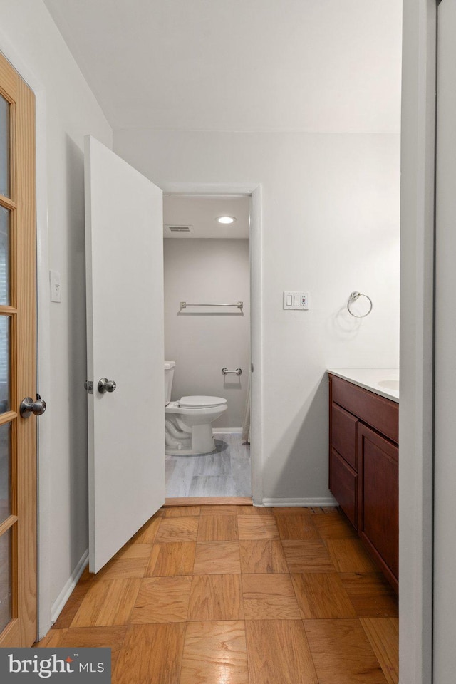 bathroom featuring vanity and toilet