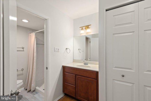 bathroom with vanity, toilet, and walk in shower