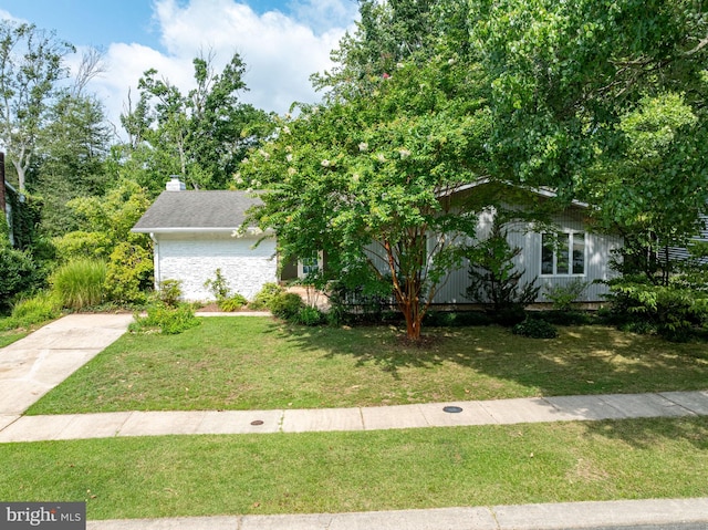 obstructed view of property featuring a front lawn