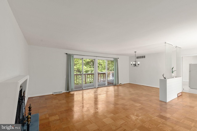 unfurnished living room with light parquet floors and a chandelier