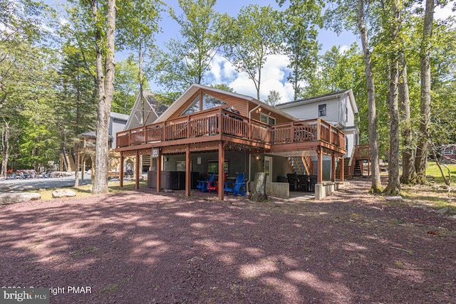 rear view of property featuring a deck