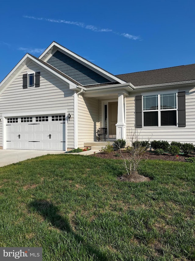 view of front of property with a garage, covered porch, and a front lawn