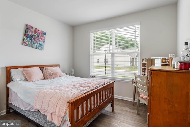 bedroom with dark wood-type flooring