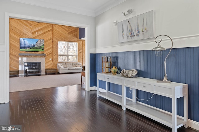 interior space with wooden walls, crown molding, and hardwood / wood-style floors