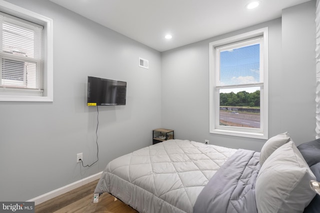 bedroom with wood-type flooring