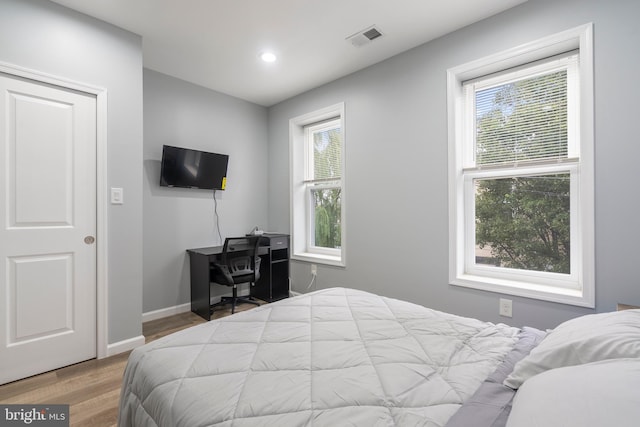 bedroom with hardwood / wood-style flooring