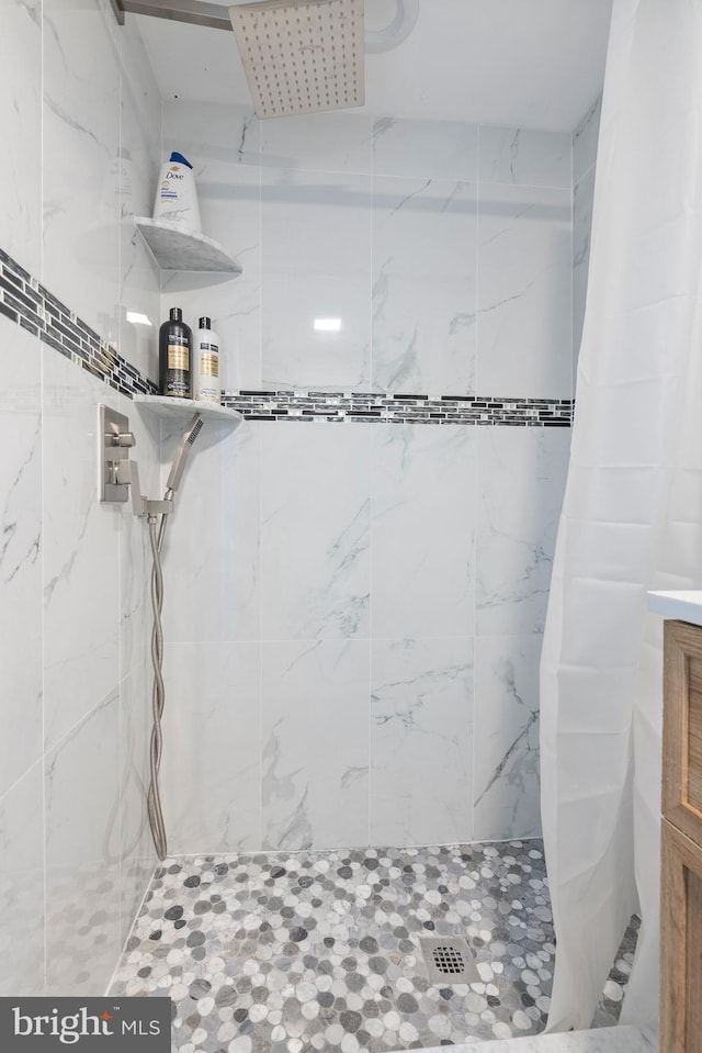 bathroom with a tile shower