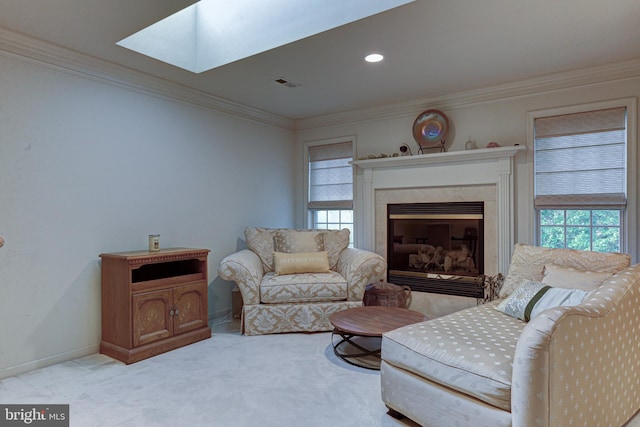 living room with light carpet, a skylight, crown molding, and a high end fireplace