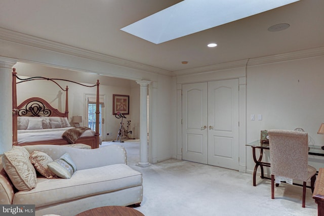 carpeted bedroom featuring crown molding, decorative columns, and a skylight