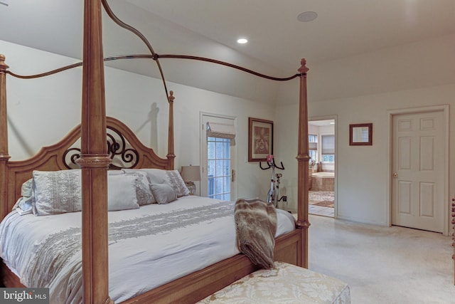 bedroom with light colored carpet and ensuite bathroom