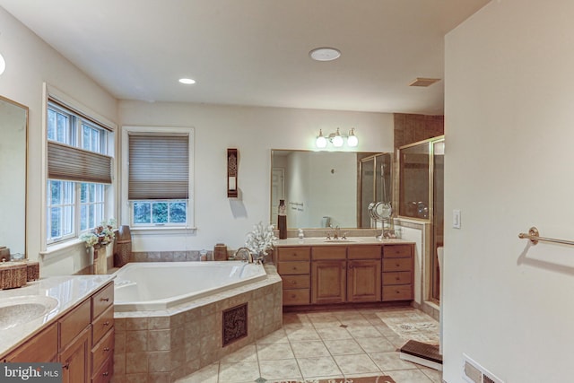 bathroom with tile patterned flooring, independent shower and bath, and vanity