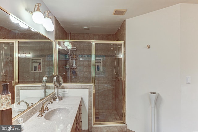 bathroom with vanity and an enclosed shower