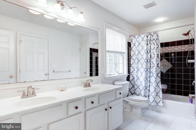 full bathroom with shower / bath combo with shower curtain, tile patterned floors, vanity, and toilet