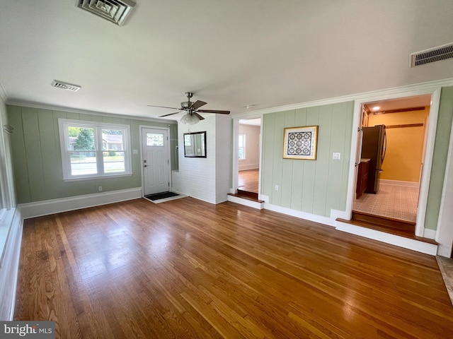 unfurnished living room with ceiling fan and wood-type flooring