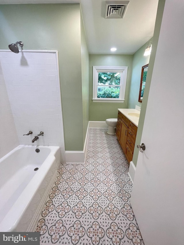 full bathroom featuring baseboards, visible vents, toilet, bathtub / shower combination, and vanity