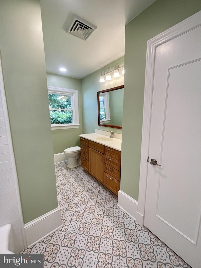 bathroom featuring tile patterned flooring, toilet, and vanity