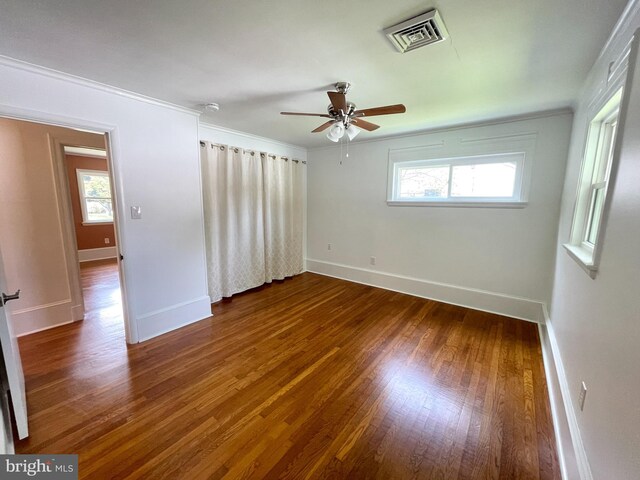 spare room with hardwood / wood-style floors, ornamental molding, and ceiling fan