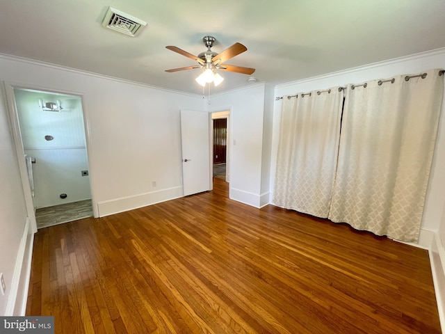 unfurnished bedroom featuring wood finished floors, a ceiling fan, visible vents, baseboards, and ornamental molding