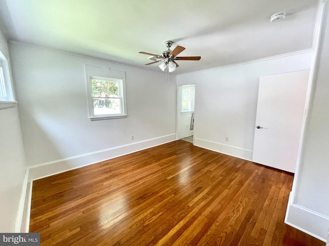 empty room with ceiling fan, wood-type flooring, and ornamental molding