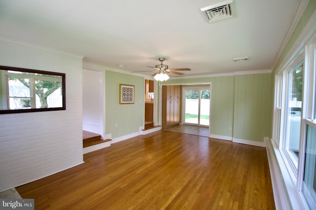 unfurnished room with ceiling fan, ornamental molding, and wood-type flooring