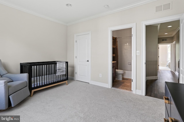 bedroom with ornamental molding, carpet, visible vents, and baseboards