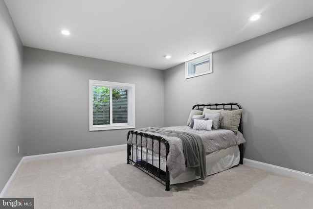 bedroom with light carpet and baseboards