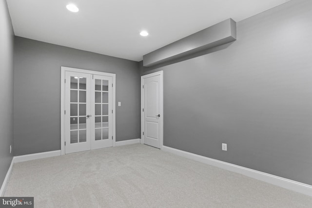 spare room featuring baseboards, french doors, recessed lighting, and light colored carpet