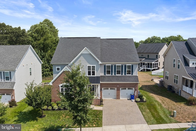 view of front of property with brick siding, decorative driveway, an attached garage, and a residential view