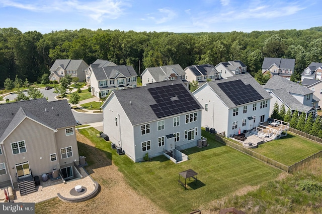 birds eye view of property with a residential view and a view of trees