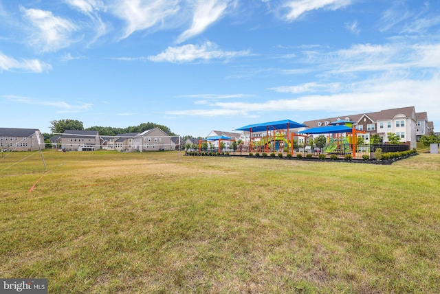 view of yard featuring a residential view and playground community