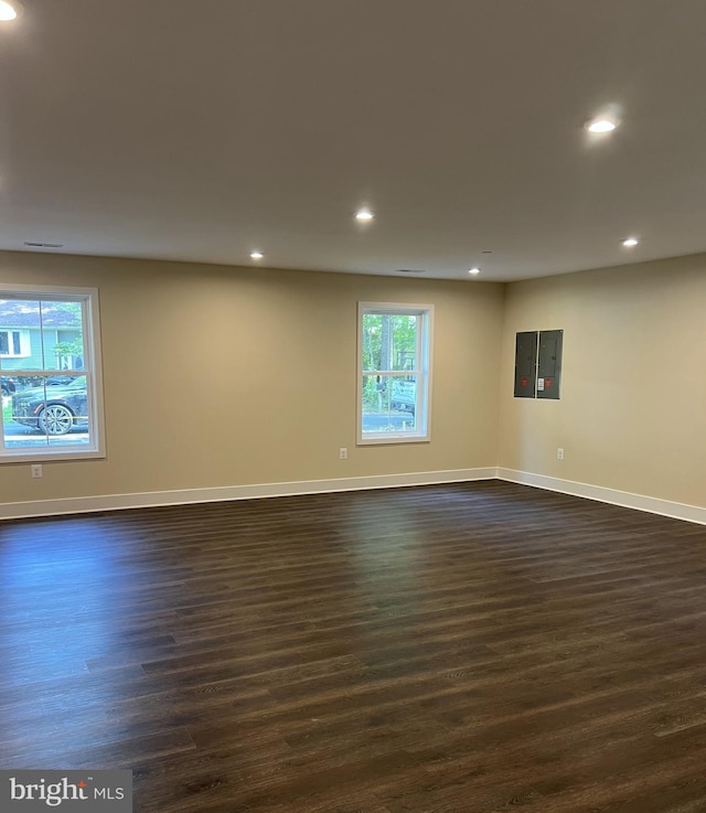 empty room with dark hardwood / wood-style flooring