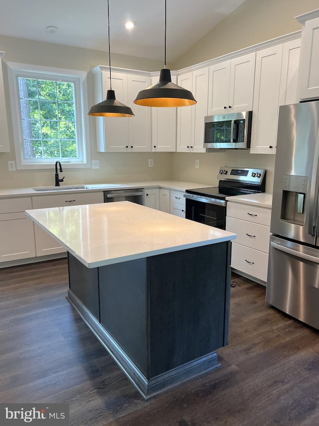 kitchen with sink, stainless steel appliances, hanging light fixtures, and white cabinets