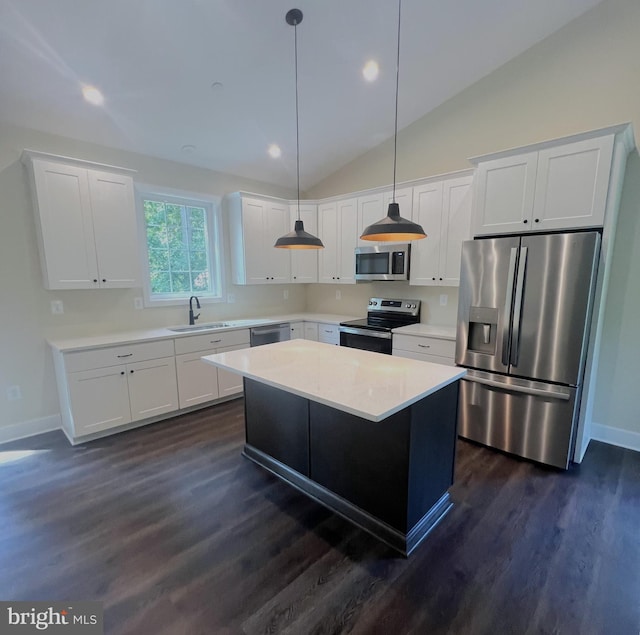 kitchen with pendant lighting, sink, white cabinetry, stainless steel appliances, and a kitchen island