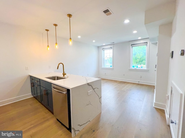 kitchen featuring dishwasher, decorative light fixtures, light hardwood / wood-style flooring, and sink