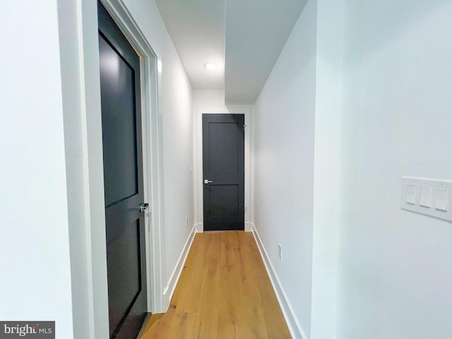 corridor with light hardwood / wood-style floors