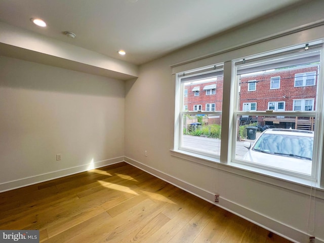 unfurnished room with light hardwood / wood-style flooring