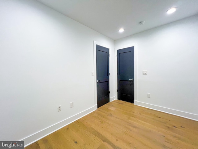 empty room with light hardwood / wood-style flooring