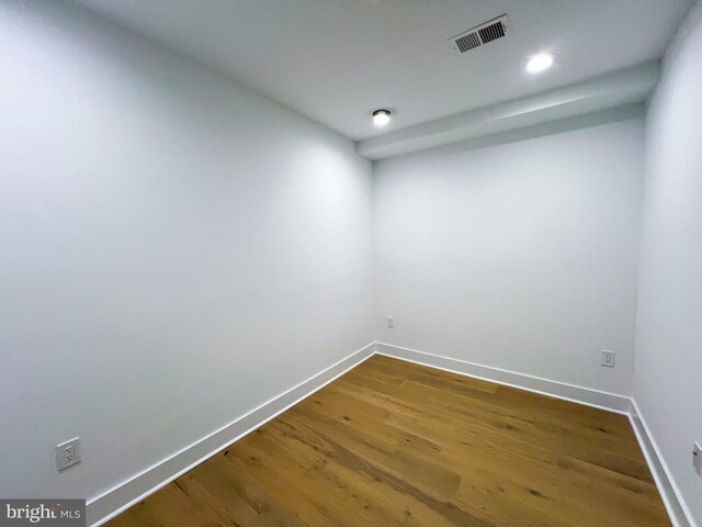 spare room featuring wood-type flooring