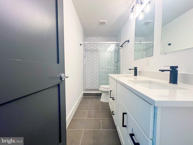 bathroom featuring vanity, tile patterned flooring, and toilet