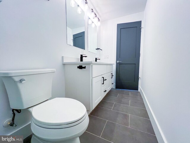 bathroom with tile patterned floors, toilet, and vanity