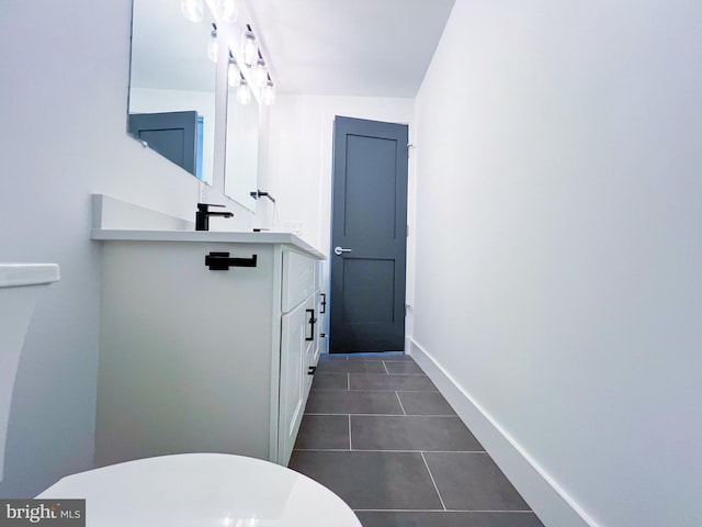 bathroom with vanity, toilet, and tile patterned floors