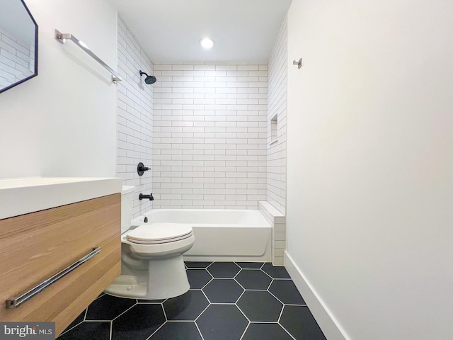 full bathroom with vanity, tile patterned flooring, tiled shower / bath combo, and toilet