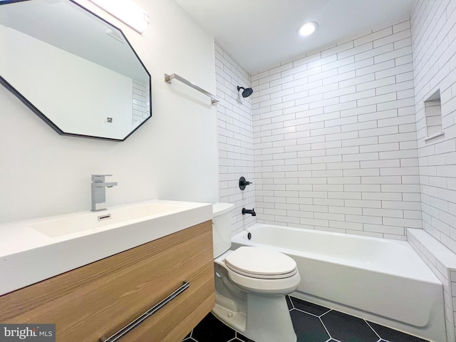 full bathroom with tiled shower / bath combo, vanity, tile patterned floors, and toilet